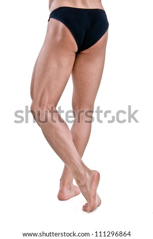 Muscled legs of a male athletic model on white background