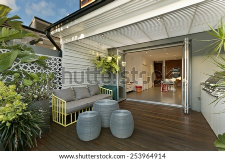 Backyard cozy patio area with wicker furniture set