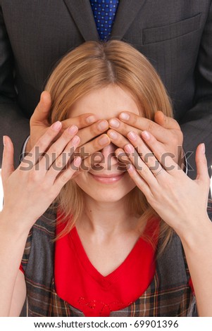 Man hands over young woman eyes close up