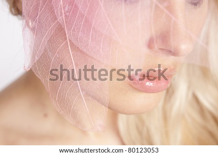close-up face. Pink lips. decorative pink tree leaves
