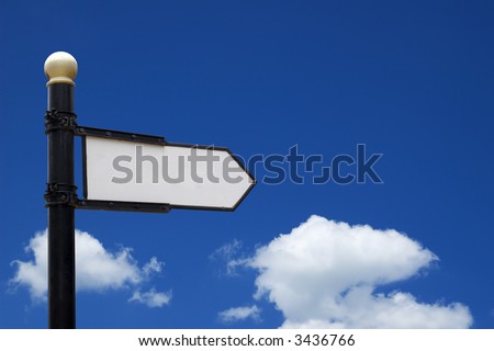 Blank sign showing into right direction in front of blue sky