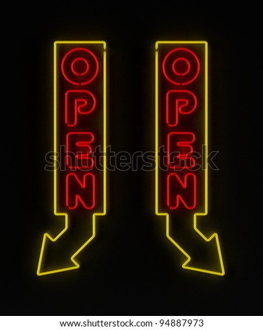 Neon sign with arrow showing an open store