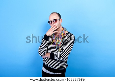 man with black glasses on blue background