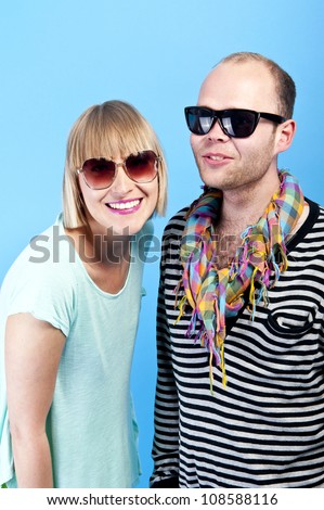 woman and man together with sunglasses on blue background