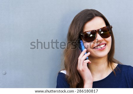 Cheerful woman talking on the phone in the street casual outfit