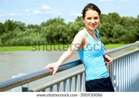 Young tired woman rest after run in the city over the bridge.