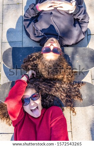 Similar – Foto Bild Zwei junge Skater, die mit den Köpfen auf ihren Boards ruhen.