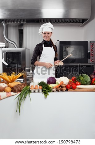 Professional female chef having fun and joy in a professional kitchen