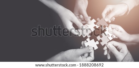 CSR (coporate social responsibility) or teamwork concept.Hands holding jigsaw.Autism awareness day kid child.business people putting jigsaw for team together.Charity, volunteer. Unity, team business.
