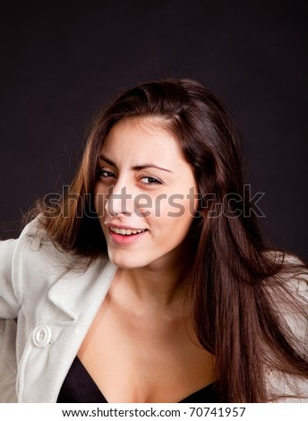 Pretty young girl with curious face expression on dark background