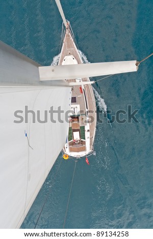 Top view of sailing boat with water splash