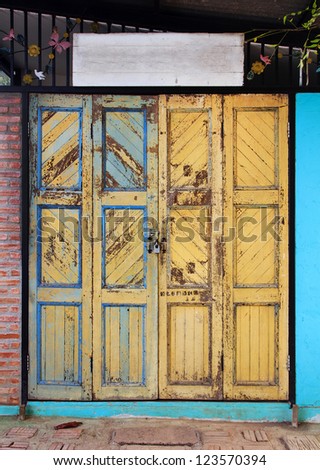 Yellow grunge wooden door background