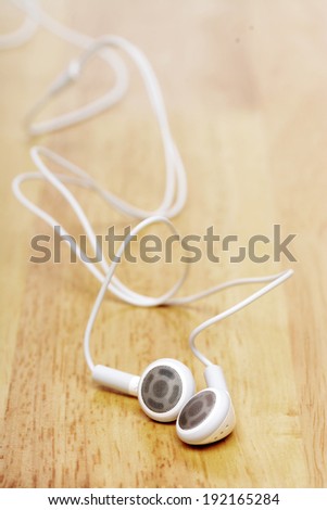 white earphone on wooden table