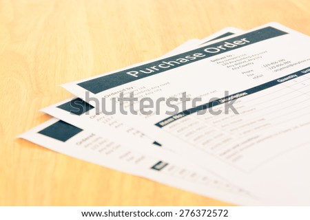 Purchase order form document on wooden table