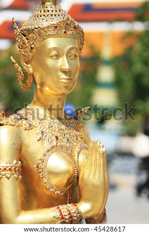 Golden demon statue sawasdee at Wat Prakaew, Thailand
