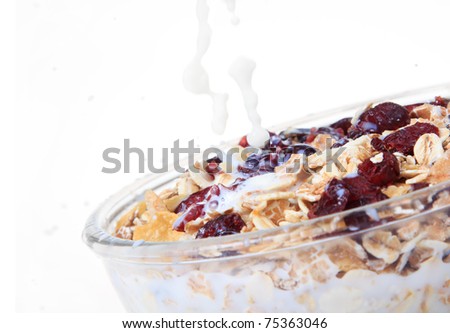 A bowl of American breakfast cereal and dry fruit isolated on white  background