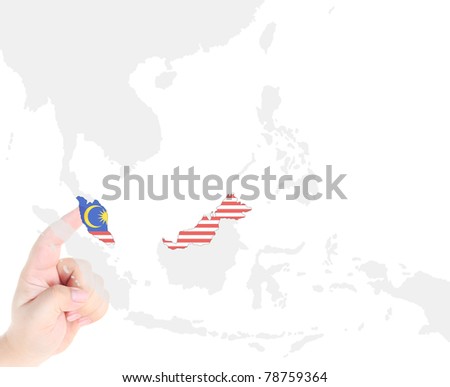 Finger touch on a future innovative transparent screen display Malaysia map and flag