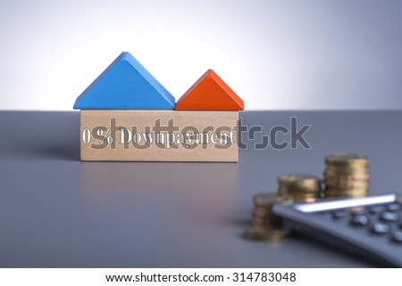 Housing Loan concept. House Wooden Block, coins and calculator with word 0% Downpayment
