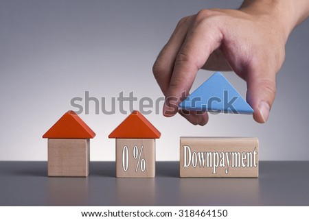 Hand holding wooden house (Housing Loan Concept) with word 0% Downpayment