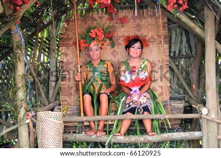 KUALA LUMPUR, MALAYSIA - NOVEMBER 28: The ethnic orang asli (aboriginal peoples) of Malay wearing traditional cloth at the Malaysia Wedding Exhibition on NOVEMBER 28, 2010 in KUALA LUMPUR, MALAYSIA