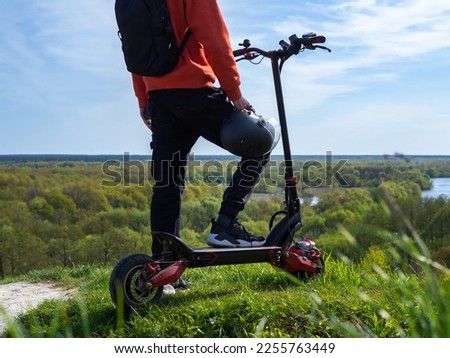 Similar – Image, Stock Photo Man riding an e-scooter