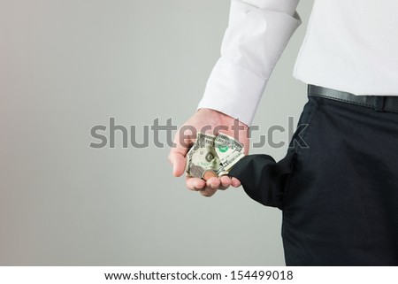 Man showing little bit of money left in his pocket