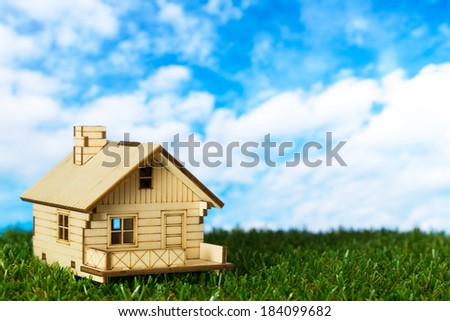 Little house model on the green grass