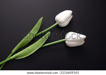 Image, Stock Photo artificial white tulips and green leaves in a black vase on the table in home interior.