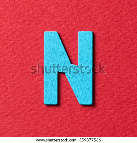 Wooden textured blue color alphabet N in red background Foto stock © 