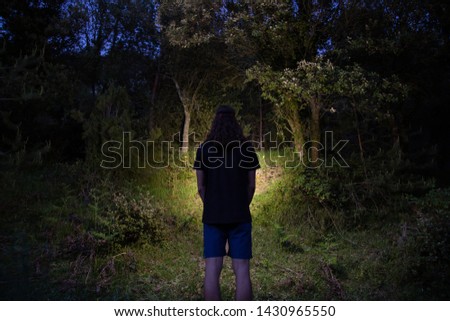 Similar – Image, Stock Photo Unrecognizable traveler with flashlight exploring foggy forest