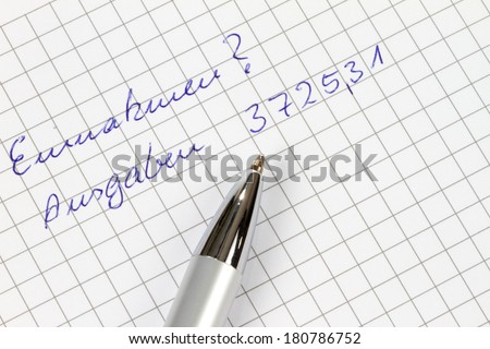 Earnings and outgoings are written in german on a checked paper decorated with a pen.