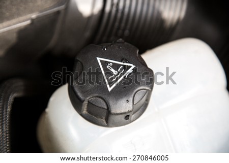 A white car water cooler inside a car engine block