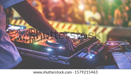 Dj mixing outdoor at new year party festival with crowd of people in background - Nightlife view of disco club outside - Soft focus on bracelet - Fun ,youth,entertainment and fest concept Сток-фото © 