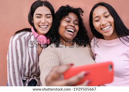 Latin girls having fun together in the city while taking selfie with mobile phone - Concept of friendship and happiness - Main focus on center young woman face Foto stock © 