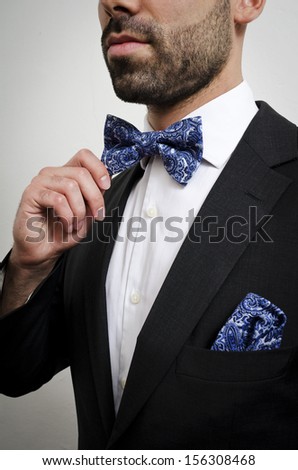 Businessman in a suit with pocket square and bow tie