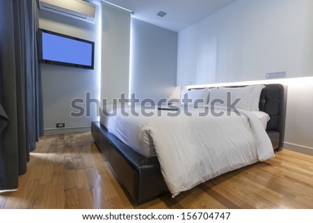 modern white bedroom with air condition and lcd tv.