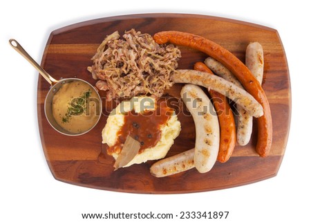 Grilled Mixed sausage served with infuse red cabbage mashed potato with gravy and mustard sauce, isolated on white.