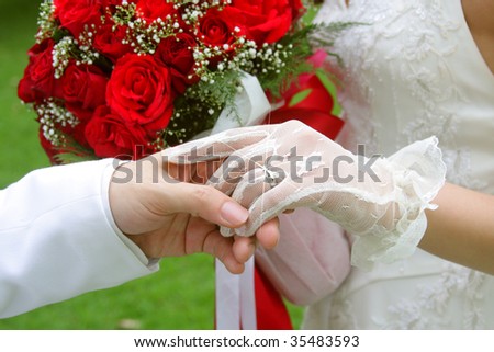 Groom holding his bride left hand, her diamond married ring flashing,meaning couple life begin goodness happiness together always and forever.