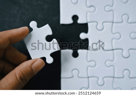 Similar – Image, Stock Photo hand holds a piece of white chalk on the background of an empty black chalk board, presentation concept