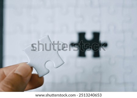 Similar – Image, Stock Photo hand holds a piece of white chalk on the background of an empty black chalk board, presentation concept