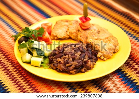 the mexican restaurant menu the beef tongue in batter with beans and salads on the yellow plate