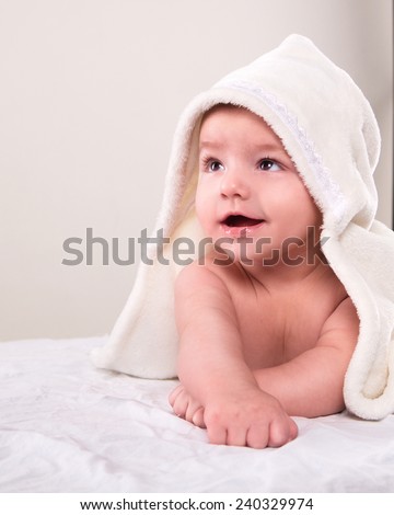 the baby on his stomach wrap white  towel on the white background