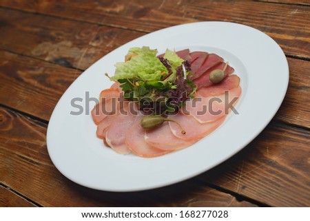 precisely cut pieces of meat seasoned with herbs