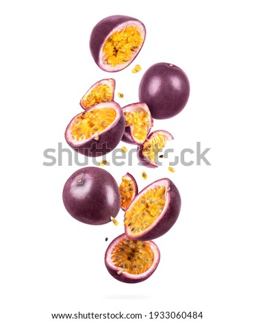 Whole and sliced ripe passion fruit in the air, isolated on a white background