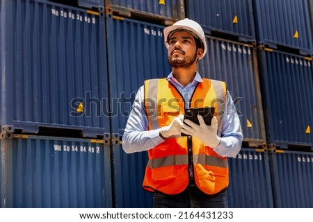 Foreman control loading containers box from factory to cargo freight ship. Container yard worker checking container at container yard warehouse. Shipping import export industry Logistics business. Stockfoto © 
