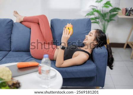 Image, Stock Photo Sportswoman lying on sports ground near basketball