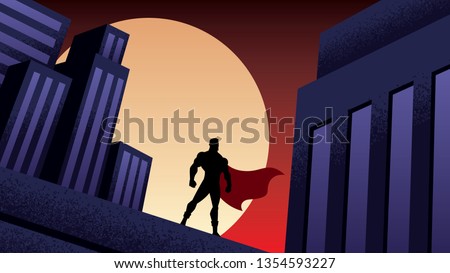 Superhero watching over the city from the roof of a tall building at night.