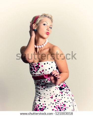 Pin-up portrait of woman straightens her hair