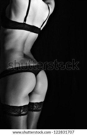 Rear view of sexual female body in black lingerie. Black and white