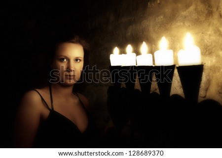 Portrait of young woman in dark mysterious castle